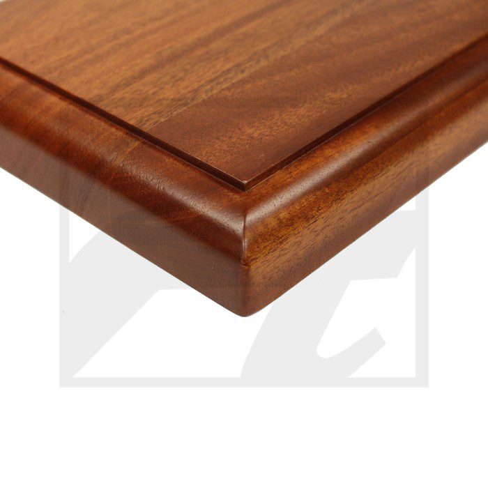 Close-up of a polished wooden cabinet door corner with a beveled edge.