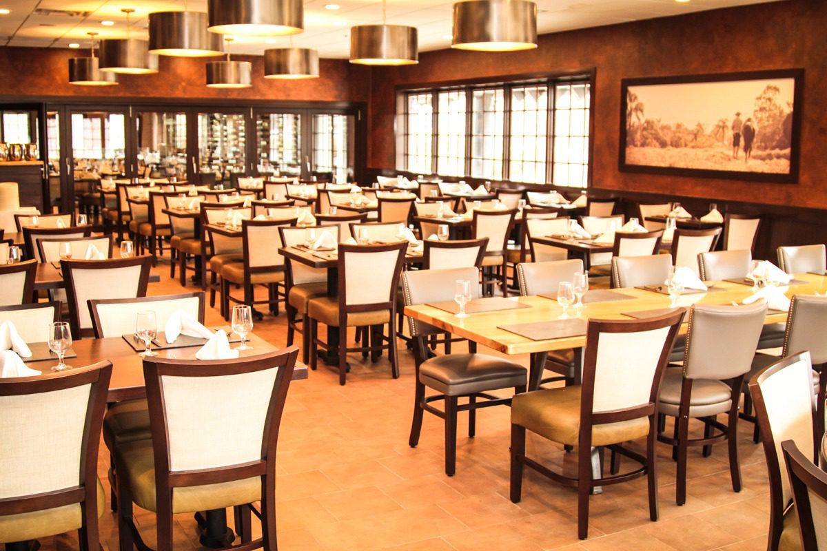 Elegant, spacious restaurant with neatly arranged tables and chairs.