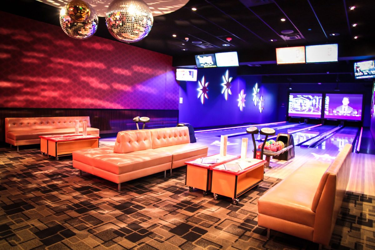 A stylish lounge area with modern sofas and vibrant lighting.