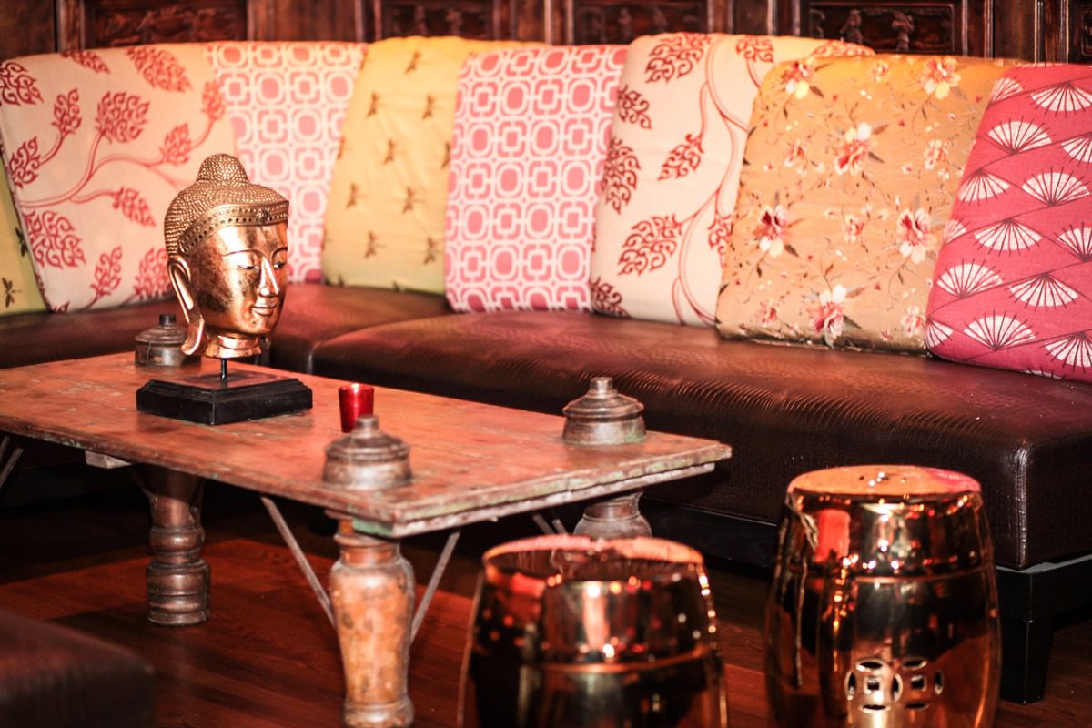 Cozy living room with colorful cushions and antique decor.