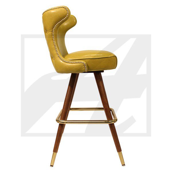 Mid-century modern mustard yellow bar stool with wooden legs and brass footrest.