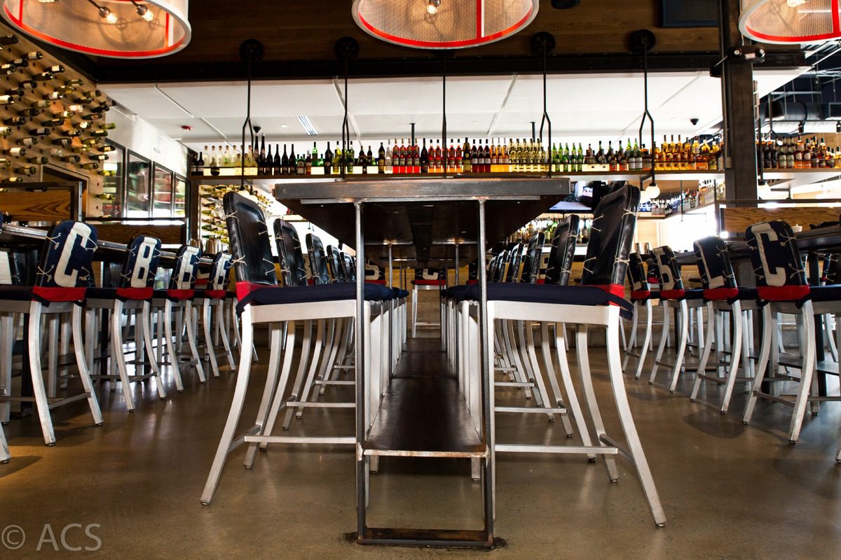 Symmetrical view of a modern restaurant with neatly arranged tables and chairs.
