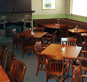 Cozy restaurant interior with wooden tables and chairs.