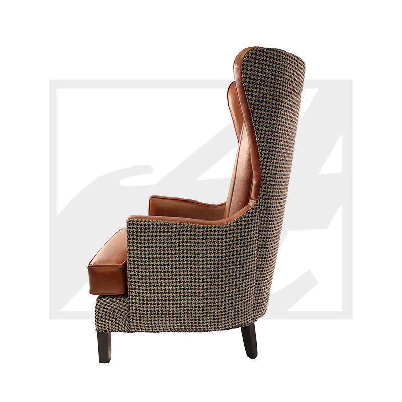 Side view of a stylish wingback armchair with patterned upholstery.