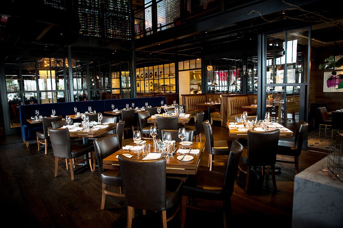 Elegant restaurant dining area with neatly set tables and warm lighting.