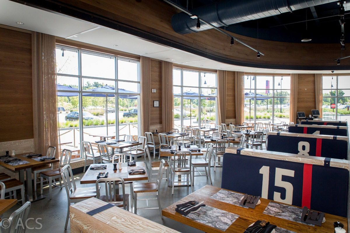 Bright, modern restaurant interior with large windows and neatly arranged tables.