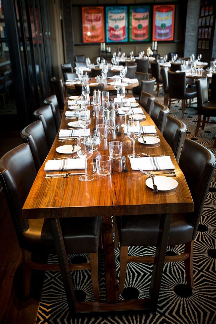 Elegant dining table set for a formal meal with glasses and plates.
