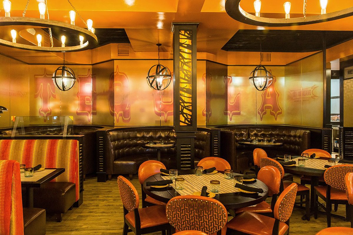 Warm, stylish restaurant interior with cozy seating and ambient lighting.