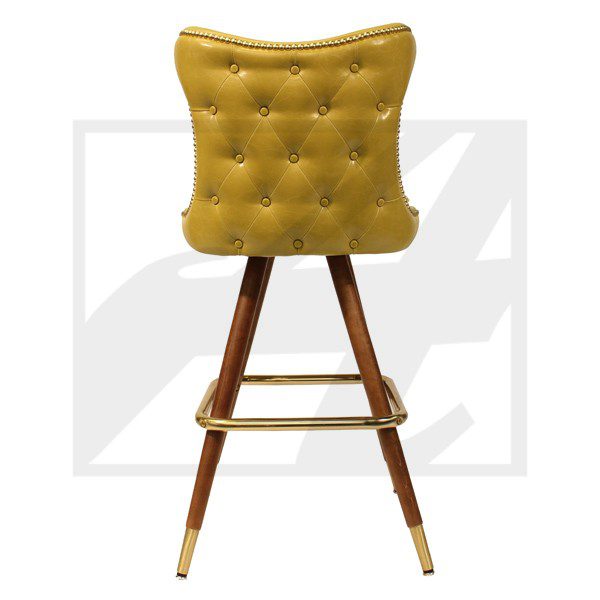 A stylish mustard-yellow tufted bar stool with wooden legs.