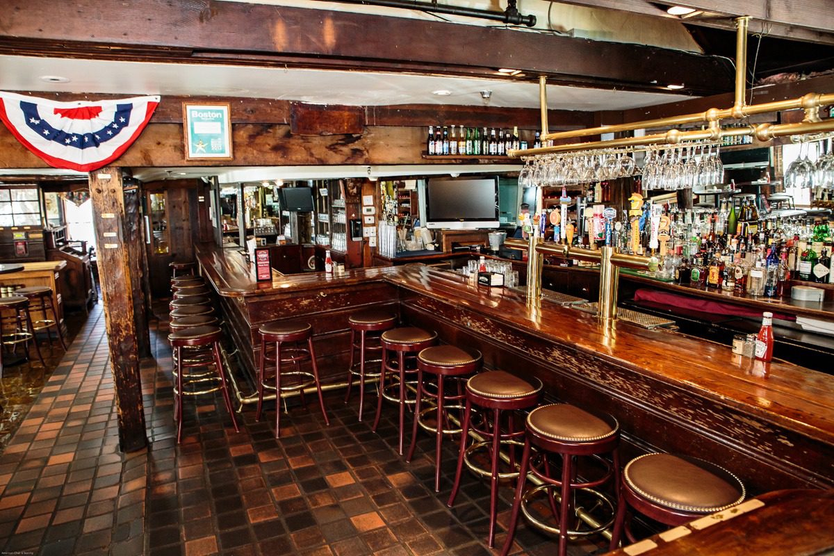 Cozy wooden bar with stools and classic ambiance.