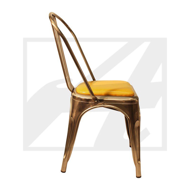 Rustic metal chair with a yellow cushion seat.