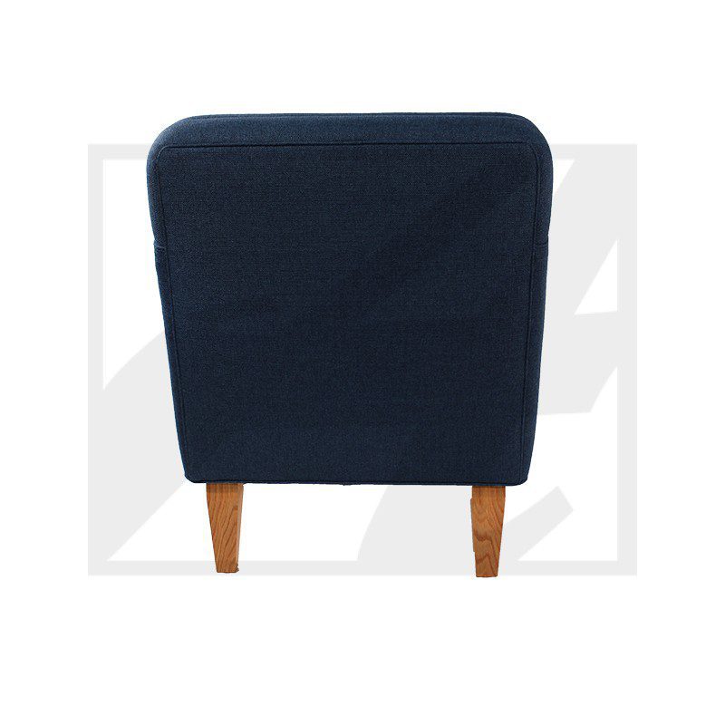 Rear view of a navy blue upholstered chair with wooden legs.