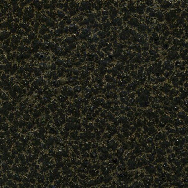 Close-up of a textured surface with dark green and black speckles.