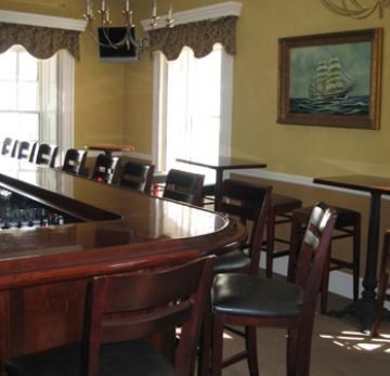 Elegant conference room with wooden chairs and large windows.