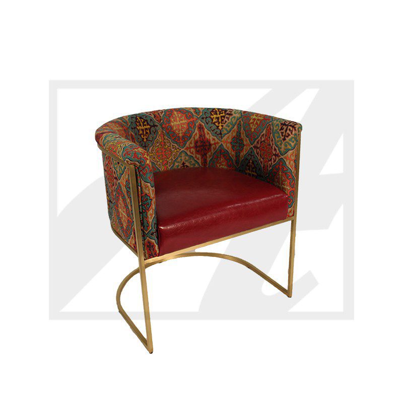 Stylish chair with floral upholstery and red cushion on gold frame.