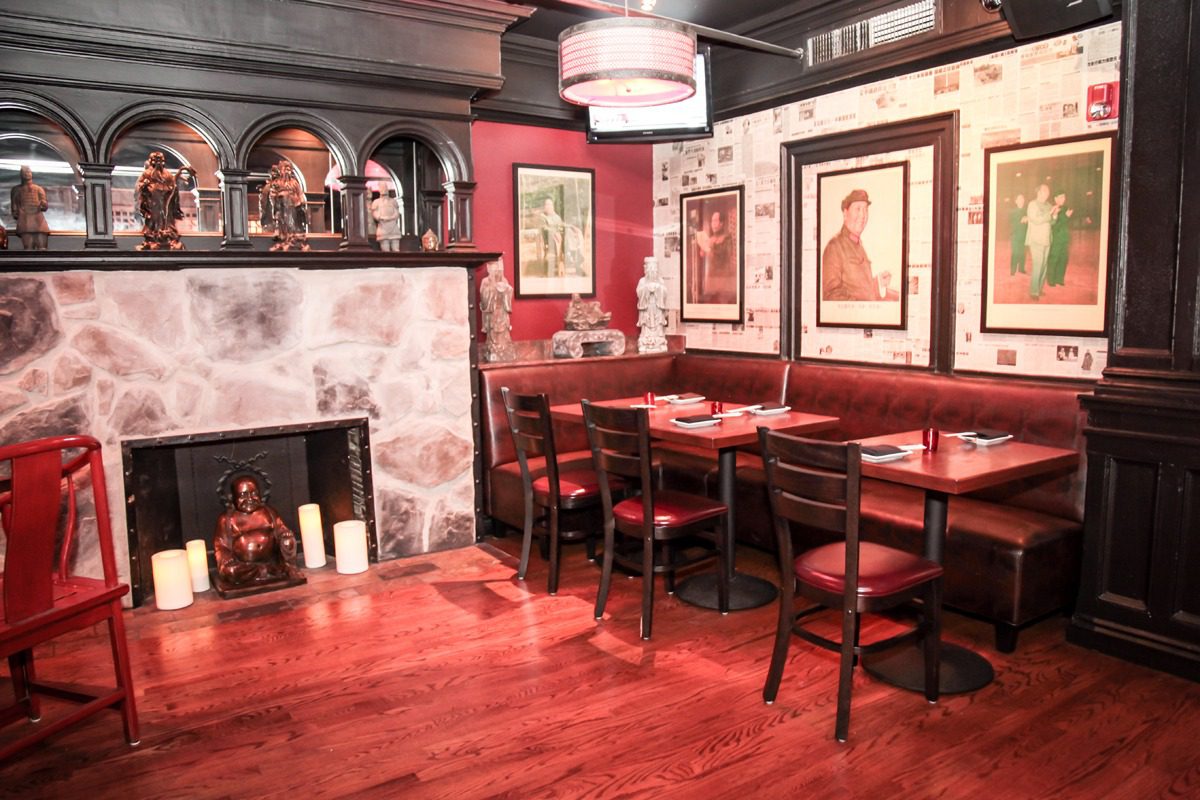Cozy dining area with wooden floors and framed artwork.