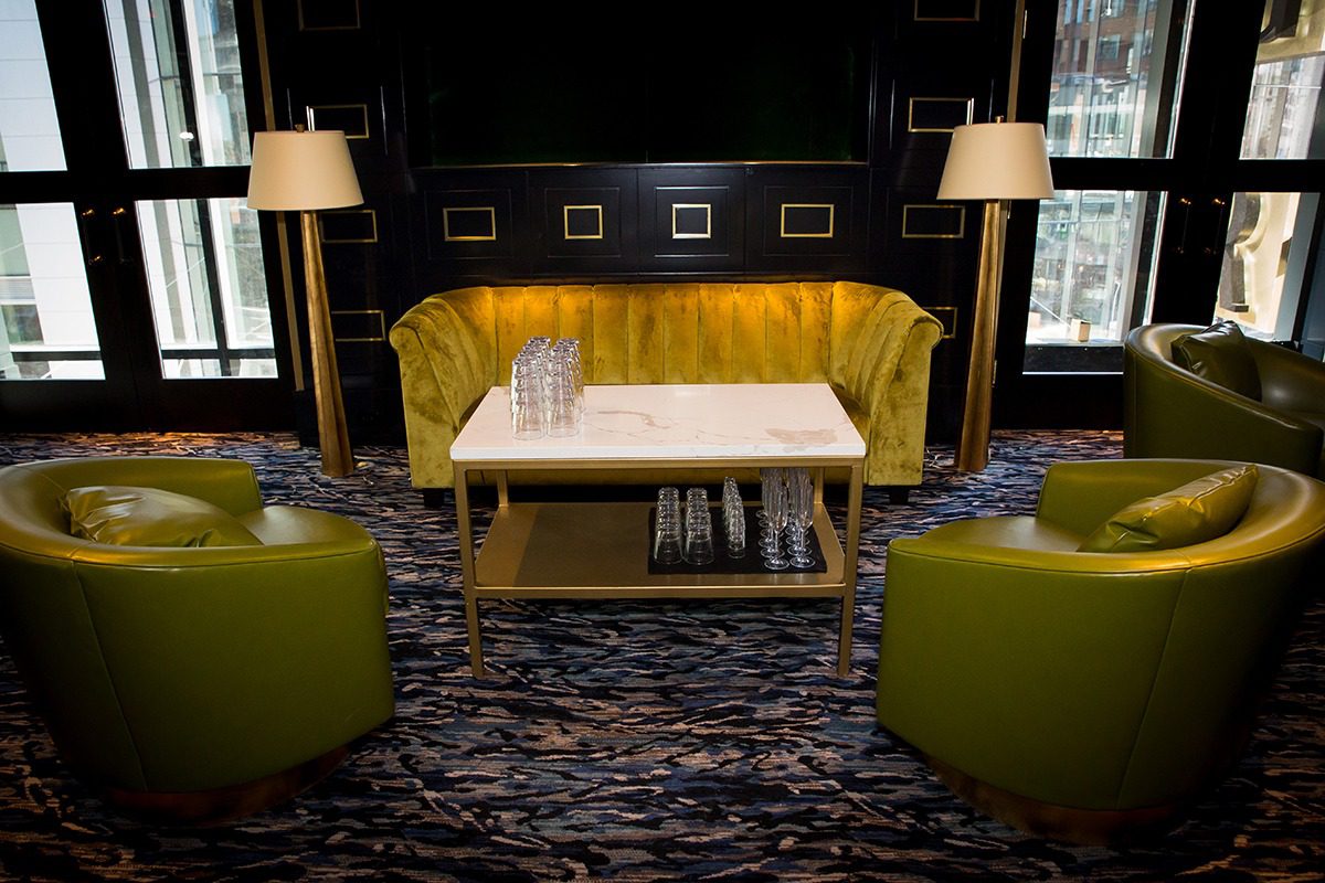 Cozy modern lounge with yellow seating and soft lighting.