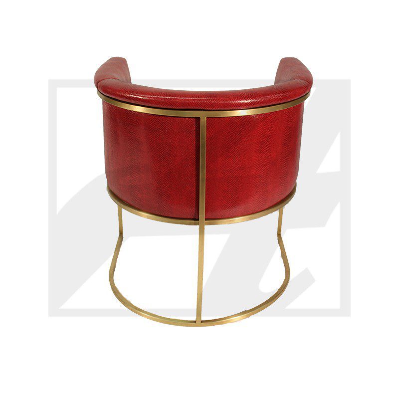 Red leather chair with gold metal frame and curved backrest.