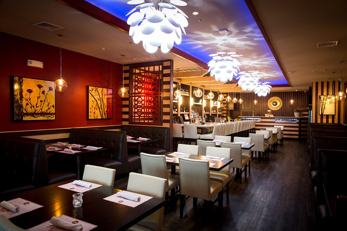 Elegant restaurant interior with modern lighting and cozy seating.