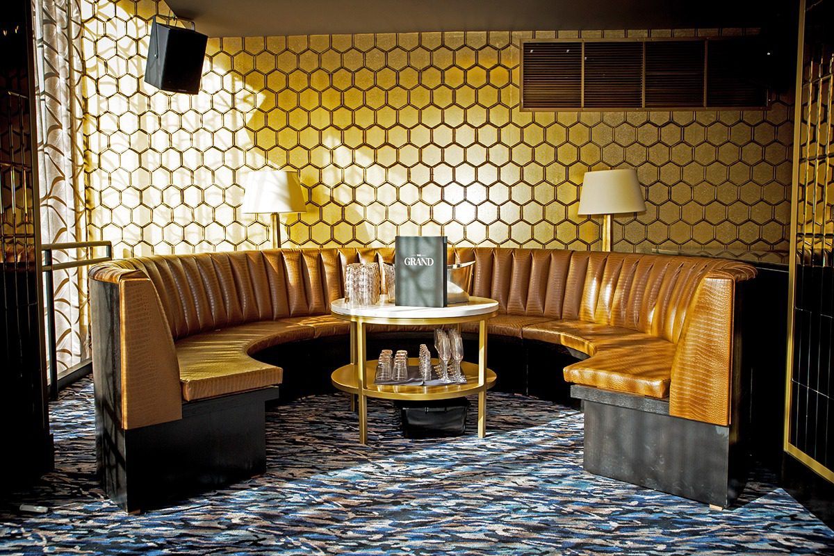 Cozy retro lounge with honeycomb wall pattern and leather seating.