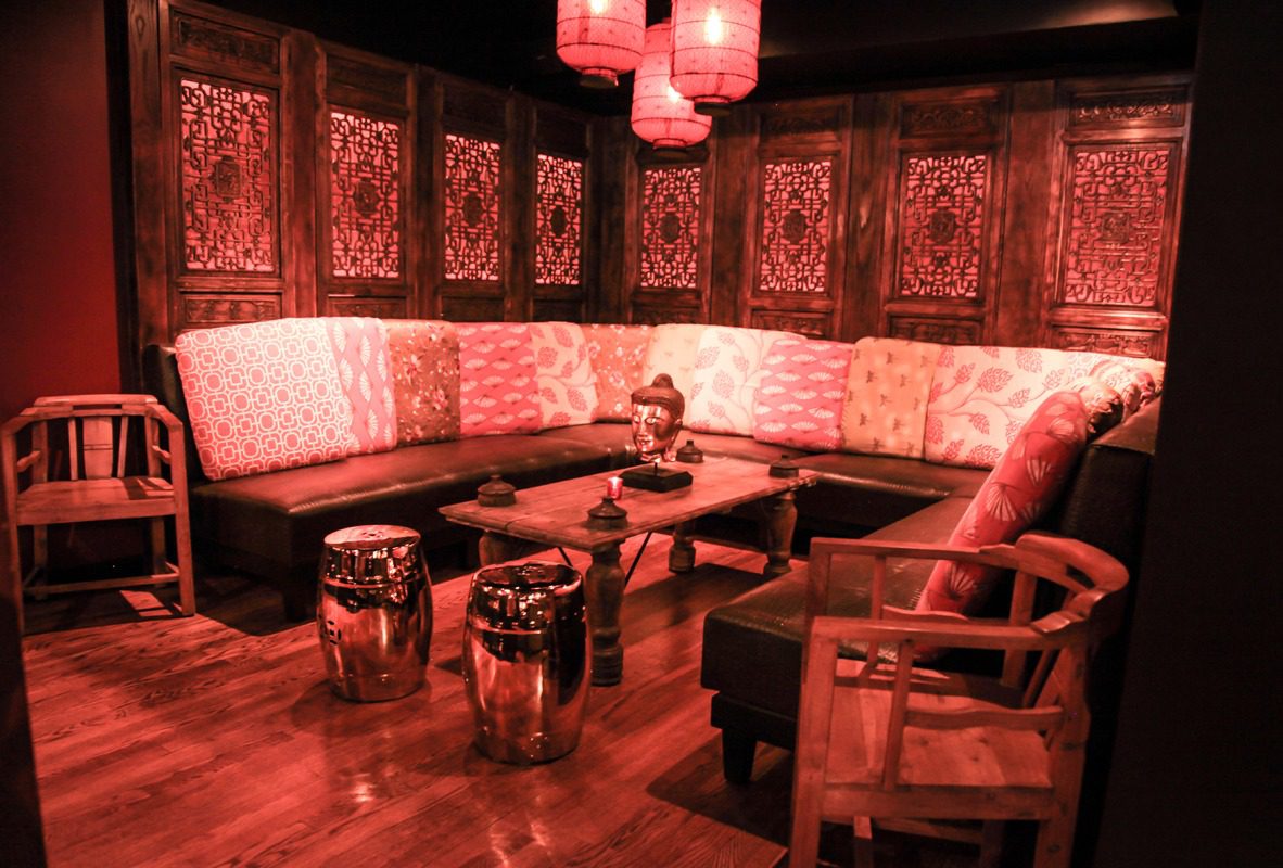 Cozy lounge with warm lighting and patterned cushions.