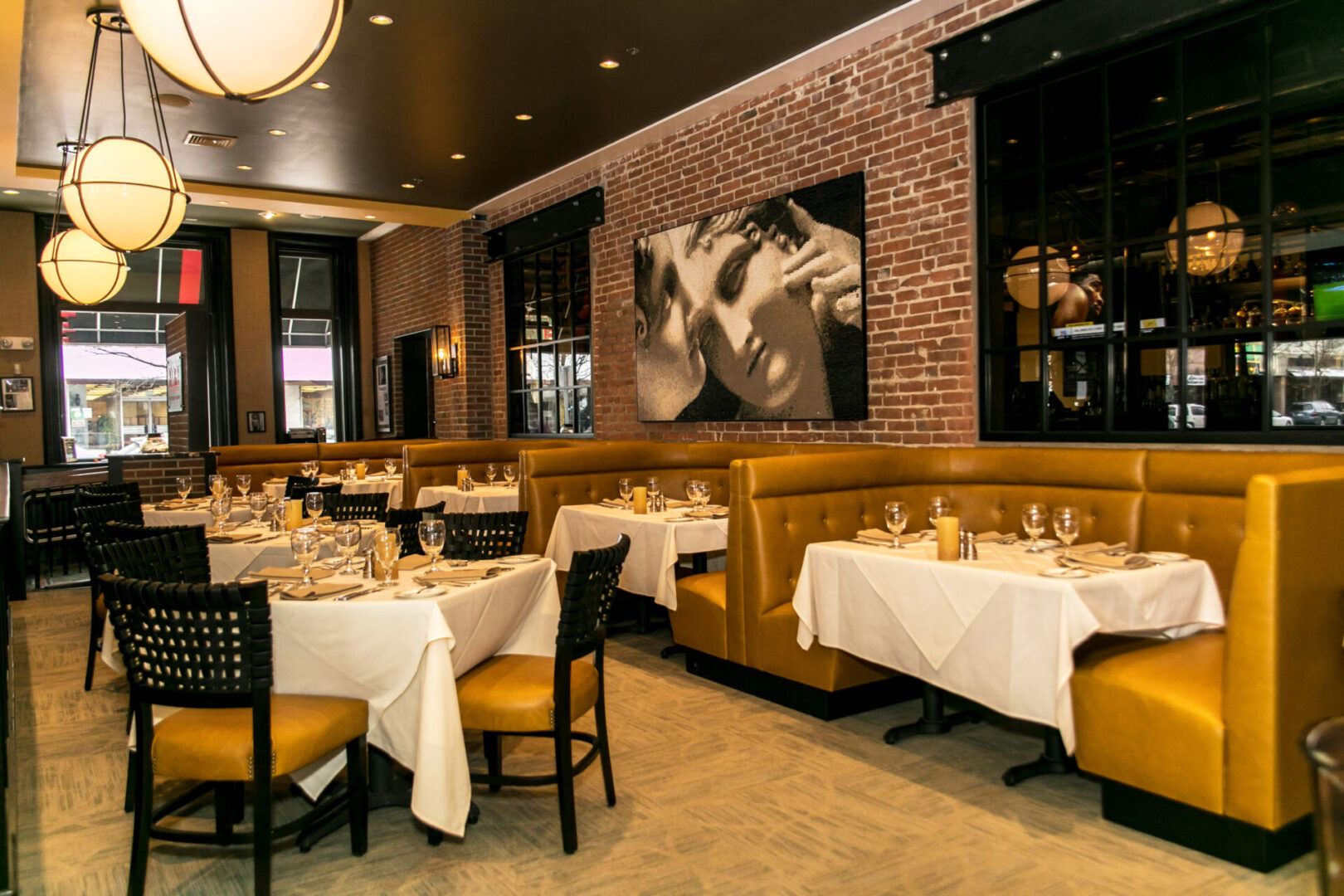 Elegant restaurant interior with white tablecloths and warm lighting.