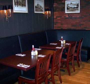 Cozy dining area with wooden tables and chairs in a restaurant.