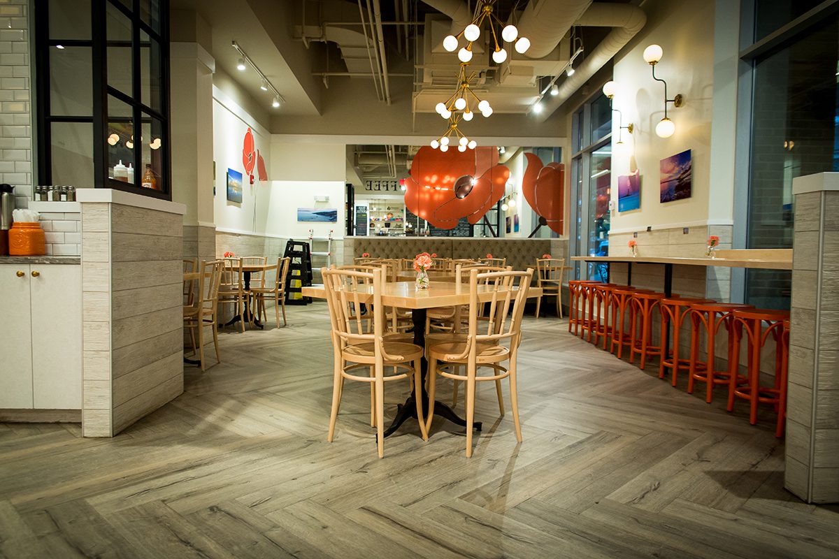 Cozy, modern dining area with wooden chairs and eclectic decor.