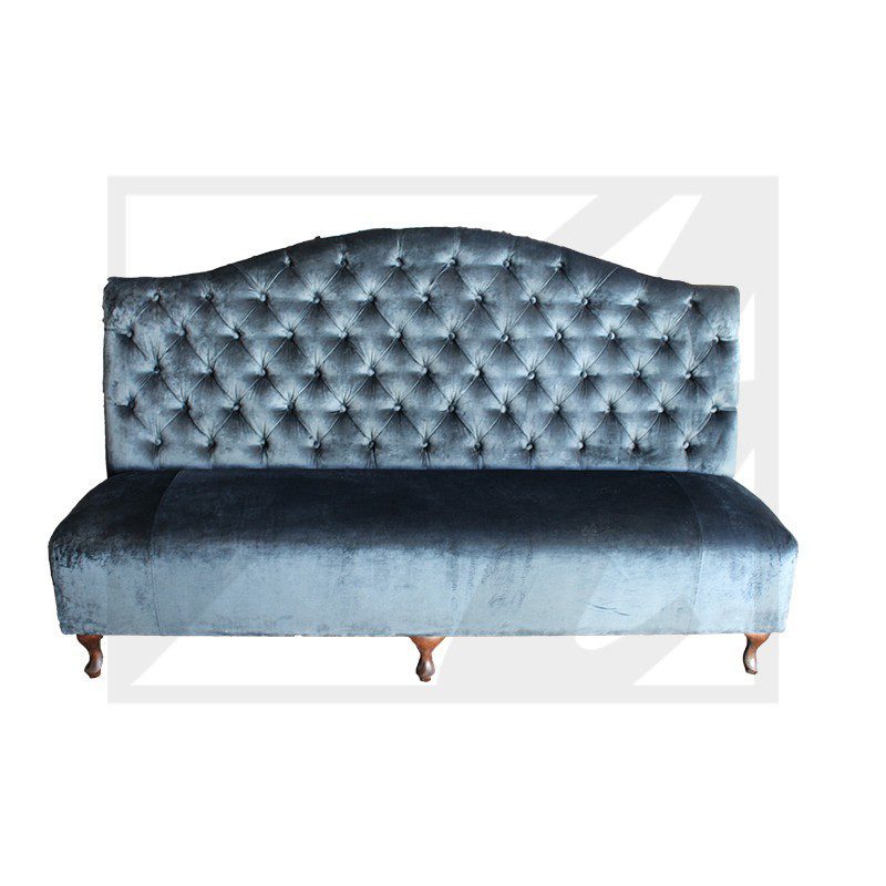 Elegant blue velvet tufted sofa with wooden legs.