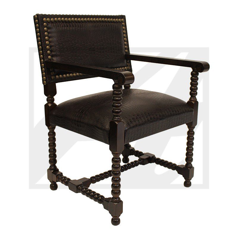 Vintage wooden armchair with dark upholstery and nailhead trim.