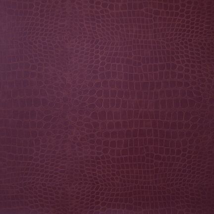 Close-up of a textured, dark purple surface with a reptile-skin pattern.