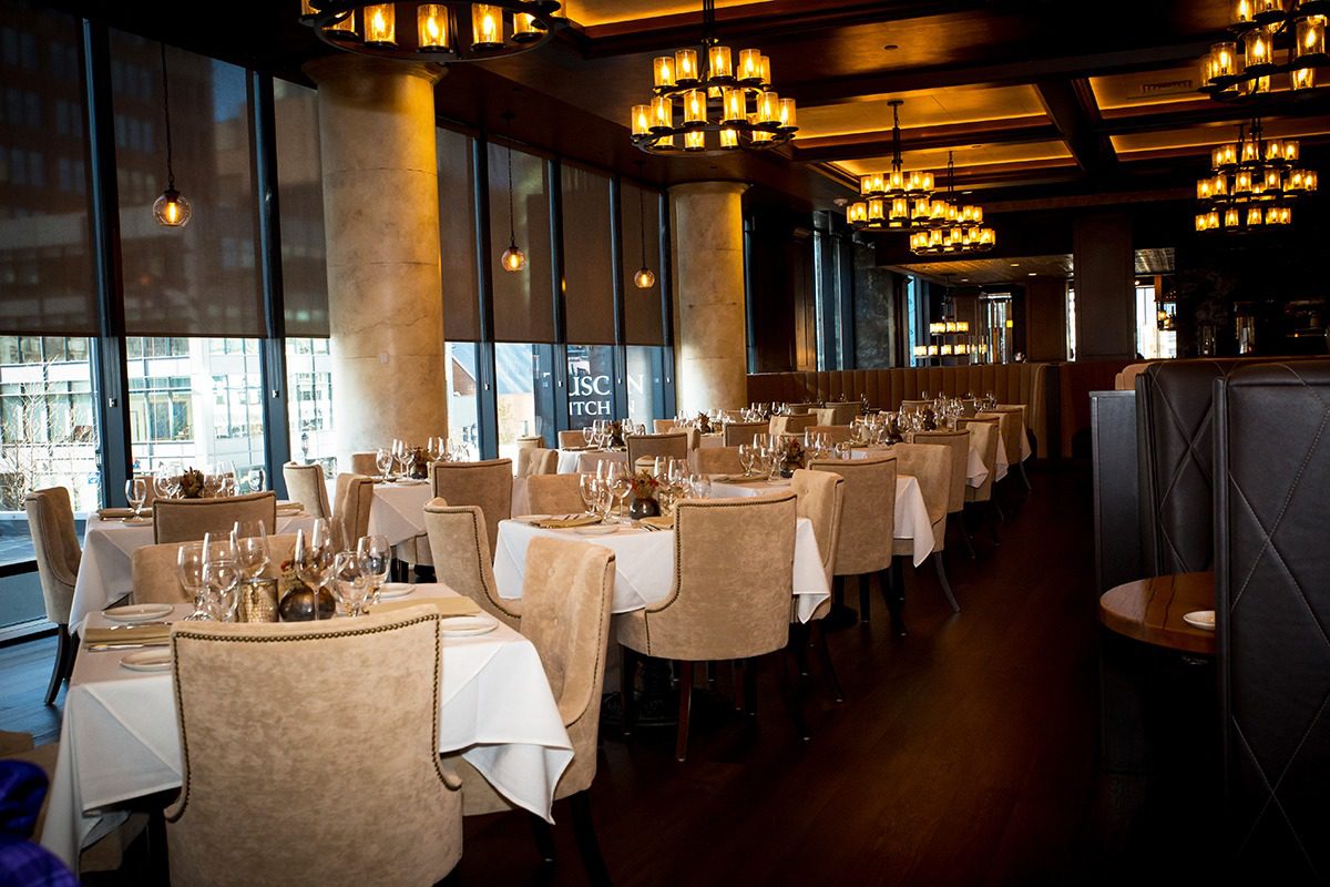 Elegant restaurant dining area with neatly arranged tables and warm lighting.