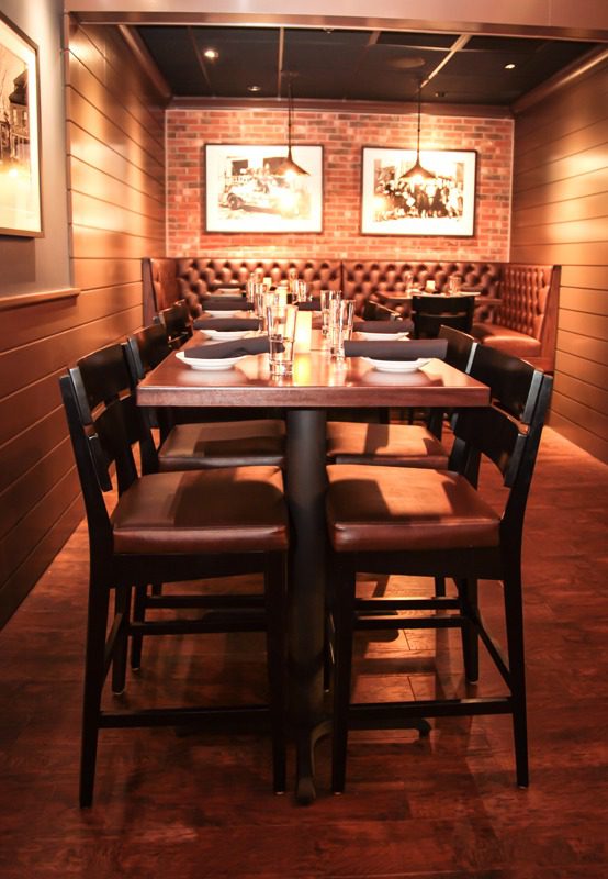 Cozy wooden dining table set for a meal in a warmly lit restaurant.