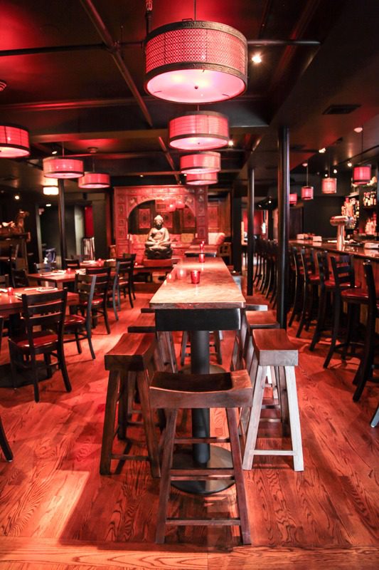 Cozy bar with warm lighting and wooden furniture.