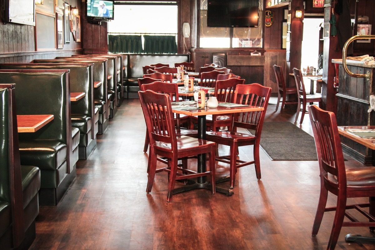Empty rustic wooden dining area with tables and chairs.