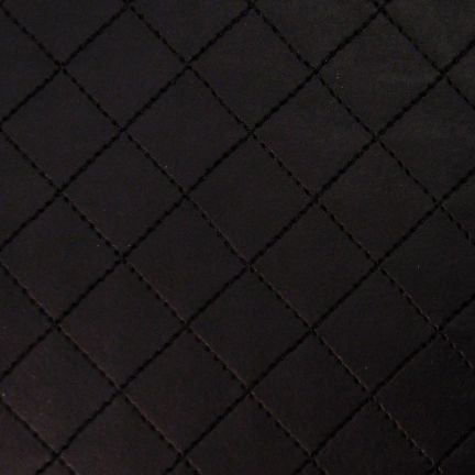 Close-up of a dark quilted fabric with diamond stitching.