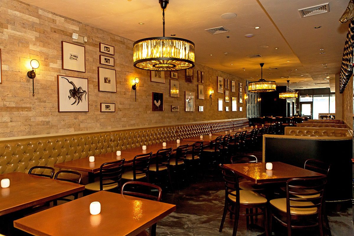 Cozy restaurant interior with warm lighting and wooden furniture.