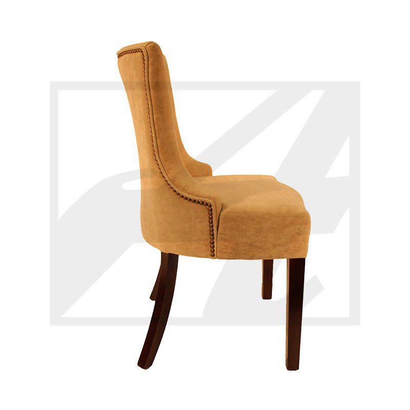 Side view of a mustard yellow upholstered dining chair with dark wooden legs.