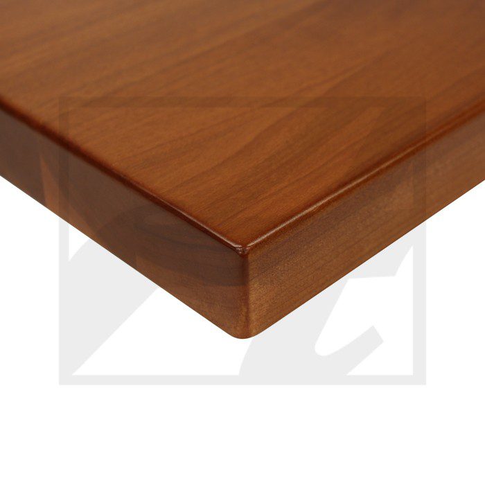 Close-up of a polished wooden tabletop corner with smooth edges.