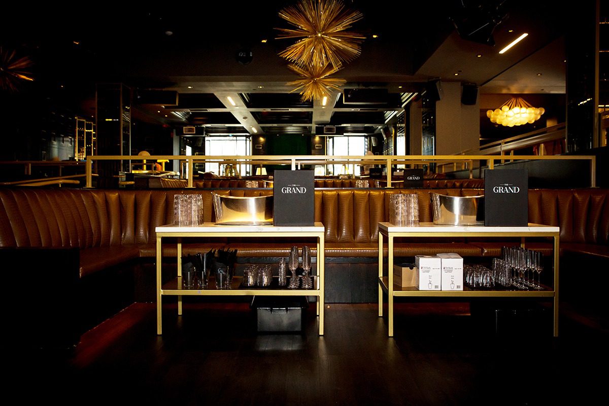 Cozy restaurant interior with warm lighting and leather seating.