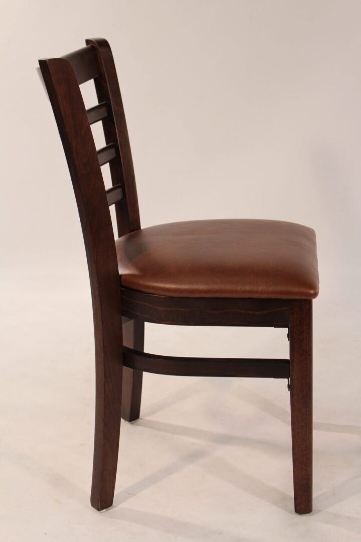 Wooden chair with a cushioned brown leather seat and slatted backrest.