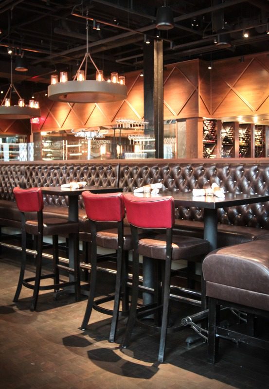 Elegant leather chairs and ambient lighting in a stylish restaurant interior.