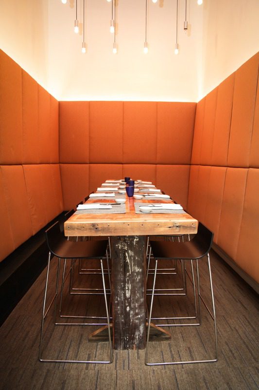 Cozy restaurant booth with a long table set for dining.