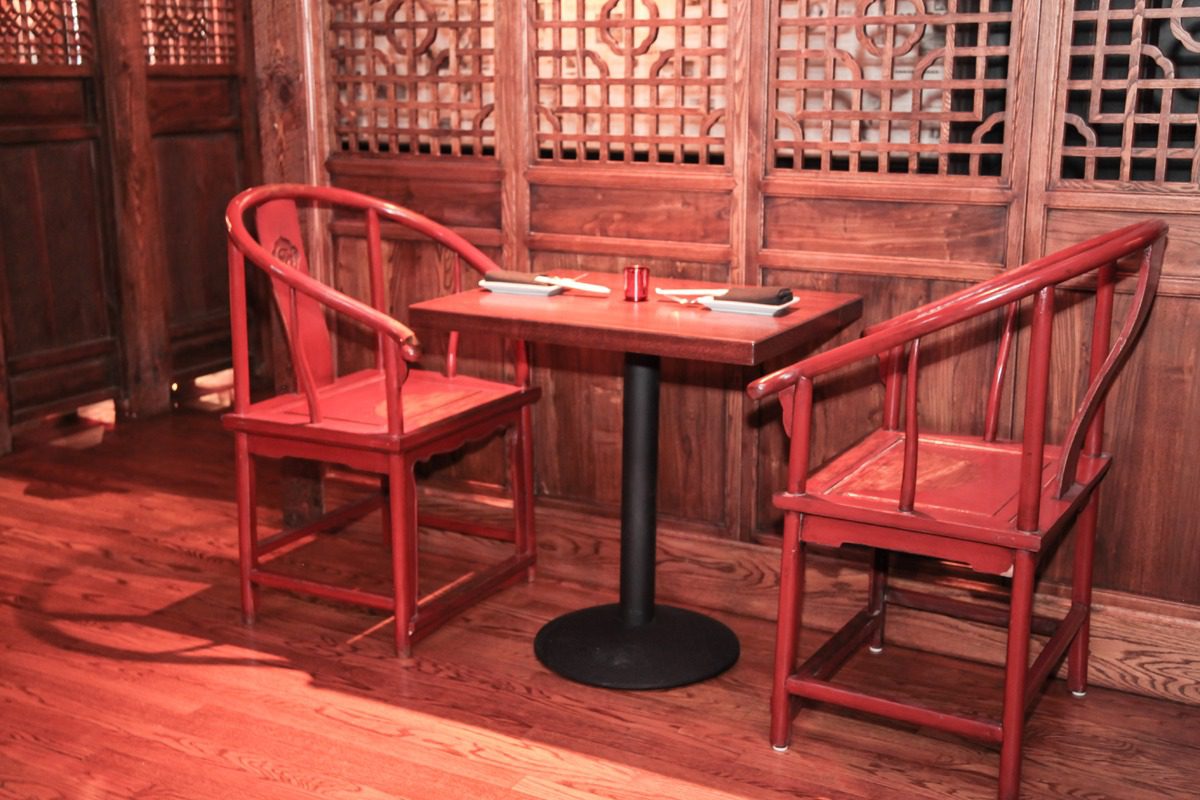 Cozy wooden seating area with a chessboard on the table.