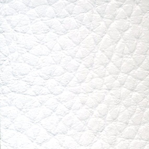 Close-up of white textured fabric with quilted diamond pattern.