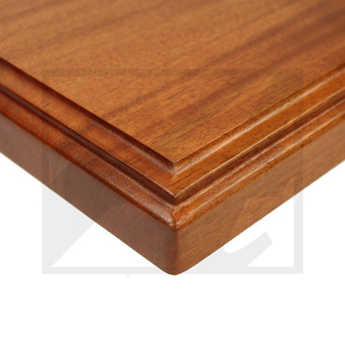 Close-up of a wooden table corner with layered edges.