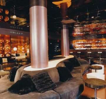Cozy modern lounge with ambient lighting and plush seating.