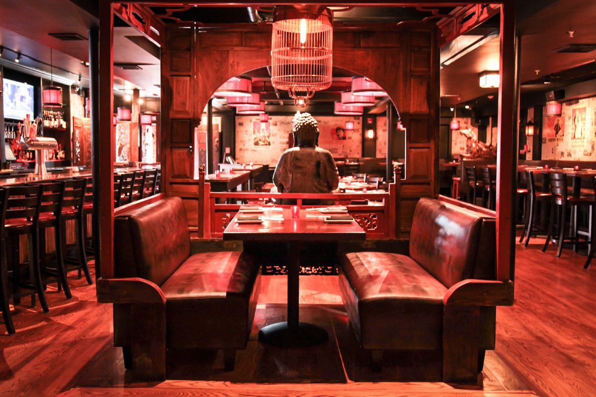 Cozy restaurant booth seating with warm lighting and wooden decor.