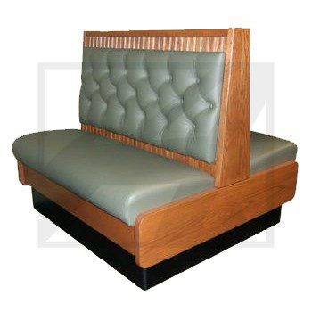 Classic green cushioned restaurant booth with wooden frame.