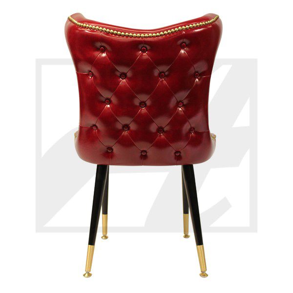 Elegant red leather chair with tufted back and gold-accented black legs.